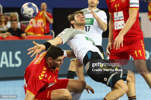 Uwe Gensheimer of Germany is challenged by Ace Jonovski of Macedonia during the Men's Handball European Championship Group C match between Germany...