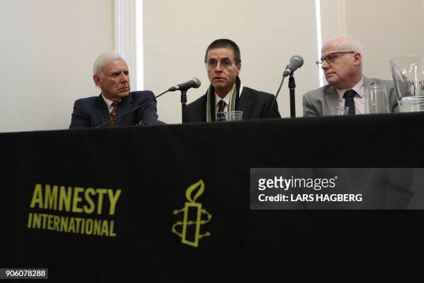 Don Bayne, Hassan Diab and Alex Neve, Secretary General of Amnesty International Canada, hold a press conference at Amnesty International Canada in...