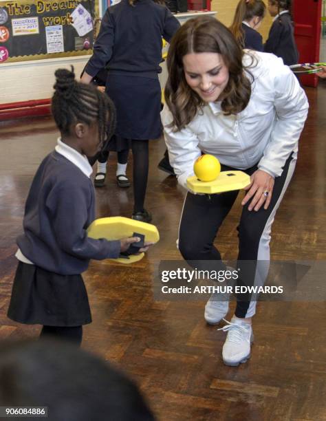 Britain's Catherine, Duchess of Cambridge and Patron of the All England Lawn Tennis and Croquet Club visits the Bond Primary School to see the work...