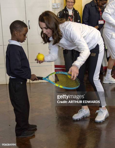 Britain's Catherine, Duchess of Cambridge and Patron of the All England Lawn Tennis and Croquet Club visits the Bond Primary School to see the work...
