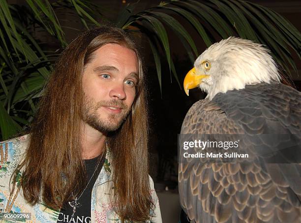 Musician Bo Bice poses with ''Challenger'' the eagle during Caregivers� Luncheon at St. Regis Monarch Beach Resort on September 11, 2009 in Dana...