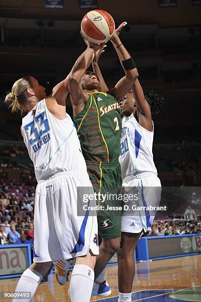 Swin Cash of the Seattle Storm looks to score against Cathrine Kraayeveld and Shameka Christon of the New York Liberty during the game on September...