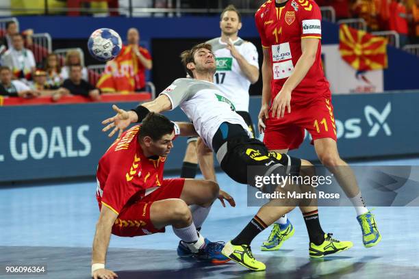 Uwe Gensheimer of Germany is challenged by Ace Jonovski of Macedonia and Filip Taleski of Macedonia during the Men's Handball European Championship...