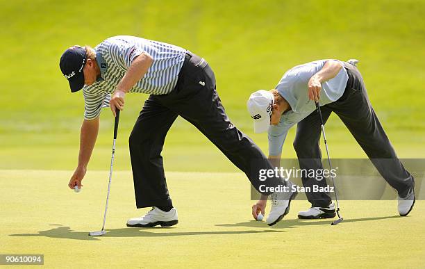 Steve Stricker and Heath Slocum attend to their golf balls at the sixth green during the second round of the BMW Championship held at Cog Hill Golf &...