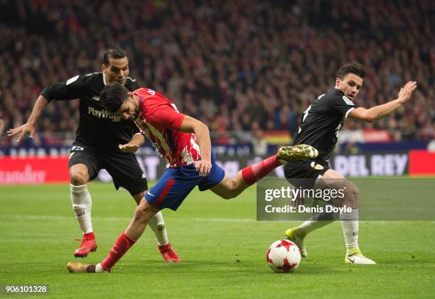 Diego Costa of Atletico Madrid in action against Sebastien Corchia and Gabriel Mercado of Sevilla during the Copa del Rey, Quarter Final, First Leg...