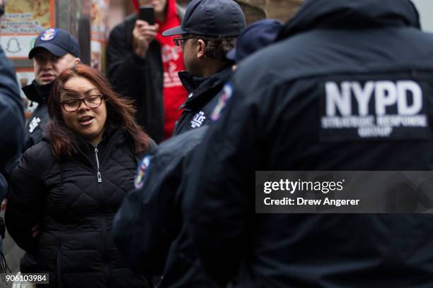 After blocking the doors to the building, an activist is arrested by members of the New York City Police Department during a rally for the passage of...