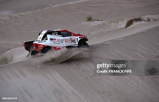 Toyota's driver Giniel De Villiers of South Africa and his co-driver Dirk Von Zitzewitz of Germany compete during the Stage 11 of the 2018 Dakar...