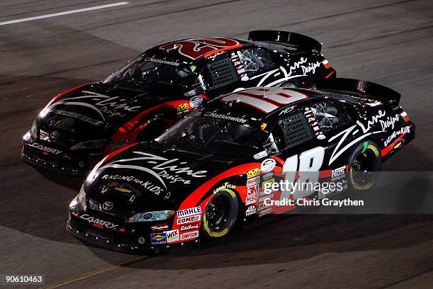 Denny Hamlin, driver of the Z-Line Designs Toyota, races teammate, Kyle Busch, driver of the Z-Line Designs Toyota, during the NASCAR Nationwide...