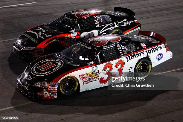 Denny Hamlin, driver of the Z-Line Designs Toyota, races Kevin Harvick, driver of the Jimmy John's Chevrolet, for the lead during the NASCAR...