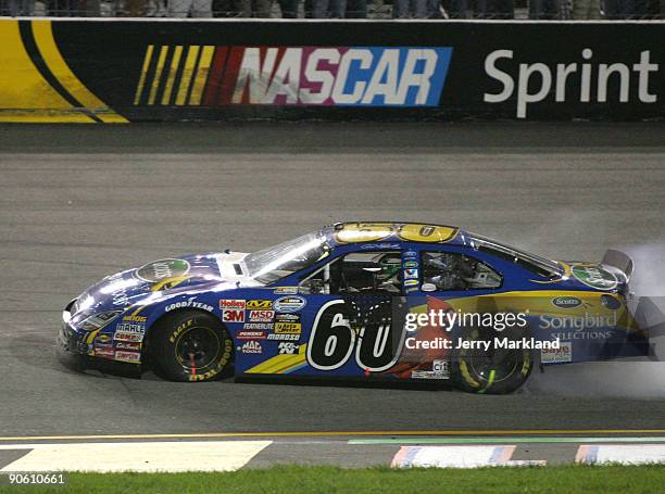 Carl Edwards, driver of the Scotts Wild Bird Food Ford celebrates with a burnout after winning the NASCAR Nationwide Series Virginia 529 College...