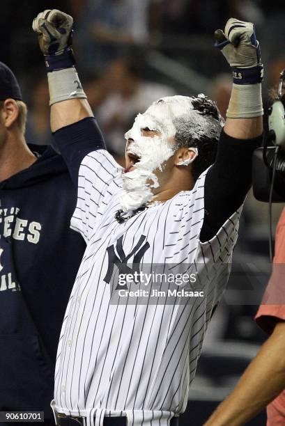 Nick Swisher of the New York Yankees celebrates his game winning walk off home run against the Tampa Bay Rays after receiving a shaving cream pie...