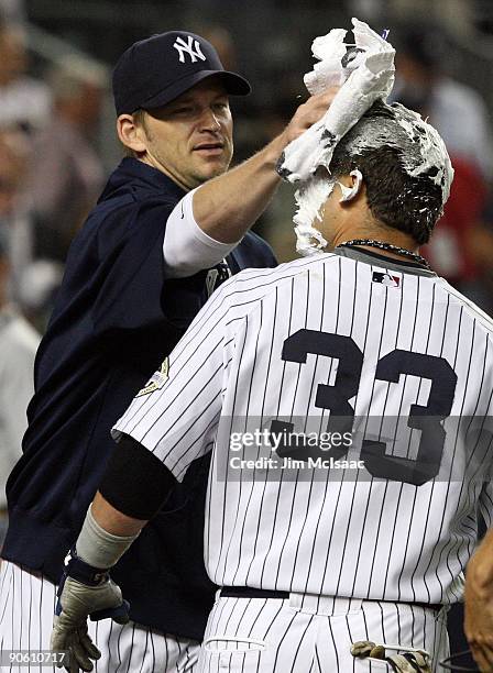 Nick Swisher of the New York Yankees receives a shaving cream pie from teammate A.J. Burnett after his game winning walk off home run against the...