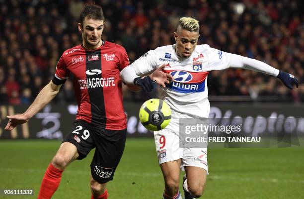 Guingamp's French midfielder Christophe Kerbrat vies Lyon's Spanish-Dominican forward Mariano Diaz during the French L1 football match between...