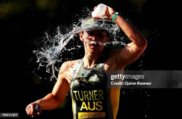 Chloe Turner of Australia tips water over her head during the run leg of the age group division of the 2009 Gold Coast ITU Triathlon World...