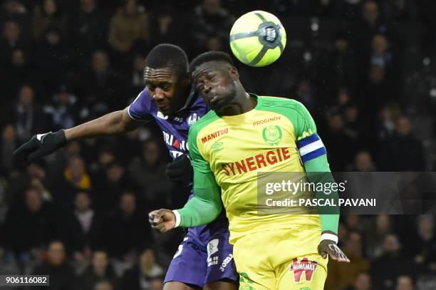 Toulouse's French defender Issa Diop vies with Nantes' French midfielder Abdoulaye Toure during the French L1 football match Toulouse against Nantes...