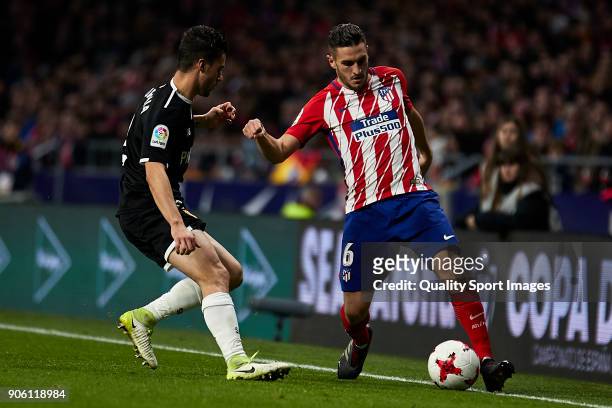 Jorge Resurrecion 'Koke' of Atletico de Madrid is challenged by Sebastien Corchia of Sevilla FC during the Copa del Rey, Round of 8, first Leg match...