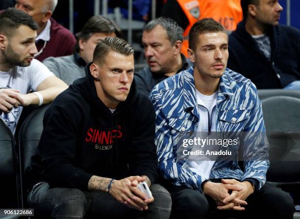 Martin Skrtel and Roman Neustadter of Fenerbahce Football Club watch the Turkish Airlines Euroleague basketball match between Fenerbahce Dogus and...