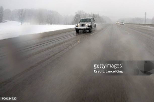 Vehicles move along Interstate 440 as snow falls on January 17, 2018 in Raleigh, North Carolina. Governor Roy Cooper declared a State of Emergency...