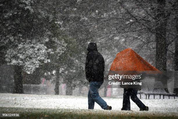 People walk along the State Capitol Grounds on January 17, 2018 in Raleigh, North Carolina. Governor Roy Cooper declared a State of Emergency...