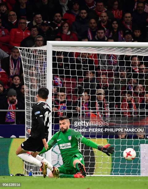 Sevilla's Argentinian midfielder Joaquin Correa scores a goal during the Spanish 'Copa del Rey' football match between Club Atletico de Madrid and...