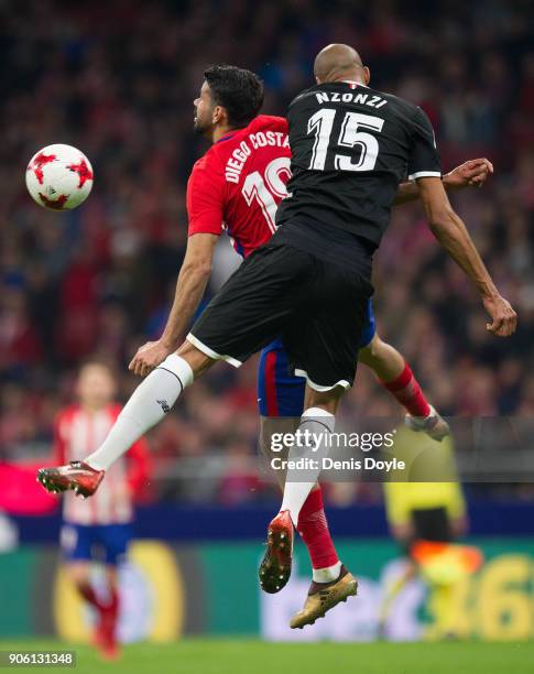 Diego Costa of Atletico Madrid heads the ball beside Steven N'Zonzi of Sevilla during the Copa del Rey, Quarter Final, First Leg match between...