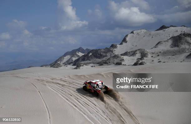 Toyota's driver Nasser Al-Attiyah of Qatar and his co-driver Matthieu Baumel of France, compete during the Stage 11 of the 2018 Dakar Rally between...