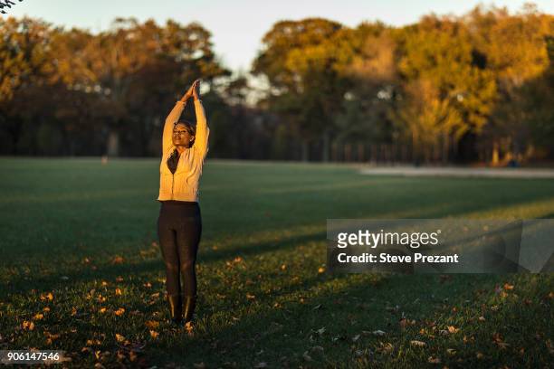 woman stretching in park - steve prezant stock pictures, royalty-free photos & images