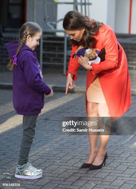 Ava Watt, aged nine with cystic fibrosis, presents Catherine Duchess of Cambridge with a gift as she visits Great Ormond Street Hospital on January...