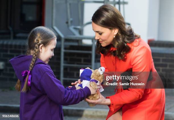 Ava Watt, aged nine with cystic fibrosis, presents Catherine Duchess of Cambridge with a gift as she visits Great Ormond Street Hospital on January...