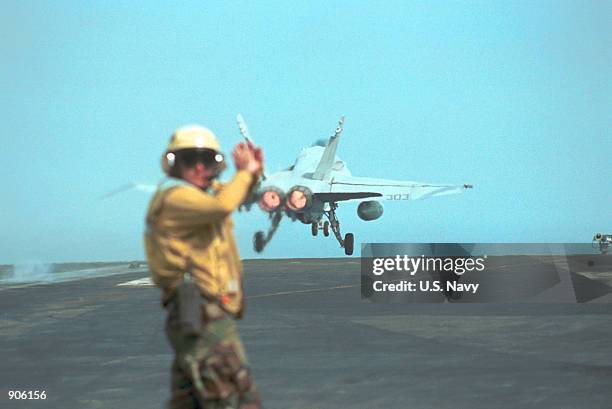 Aviation Boatswain's Mate 1st Class Larry Tarver from Gloucester, VA signals to flight deck personnel following the launch of an F/A-18 "Hornet...