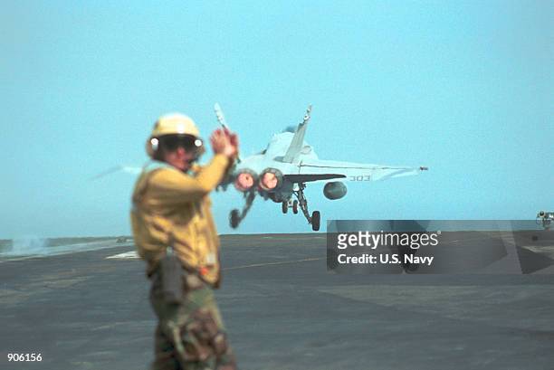 Aviation Boatswain's Mate 1st Class Larry Tarver from Gloucester, VA signals to flight deck personnel following the launch of an F/A-18 "Hornet...