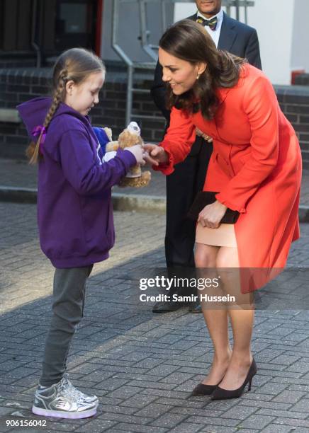 Ava Watt, aged nine with cystic fibrosis, presents Catherine Duchess of Cambridge with a gift as she visits Great Ormond Street Hospital on January...