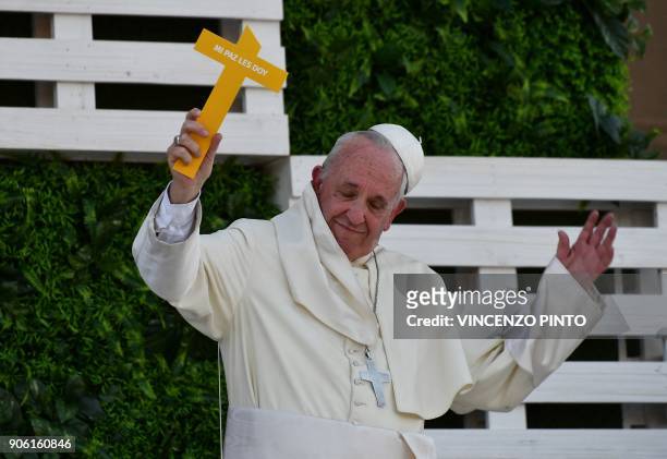 Pope Francis gestures as his skullcap blows away, during a meeting with youths at the National Shrine of Maipu in Santiago, on January 17, 2018. -...