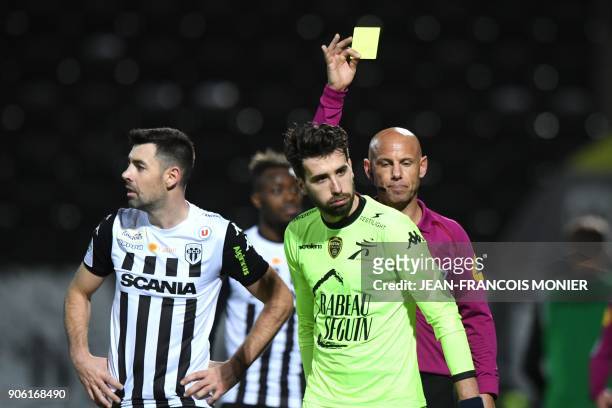 French refere Amaury Delerue gives a yellow card to Troyes' French defender Mathieu Deplagne during the French L1 Football match between Angers and...