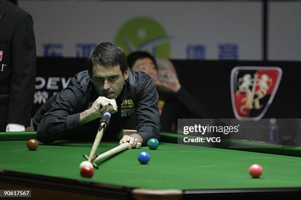 Ronnie O'Sullivan of plays a shot in the match against Ding Junhui of China during day five of the 2009 Shanghai Snooker Msater at Pontin's Prestatyn...