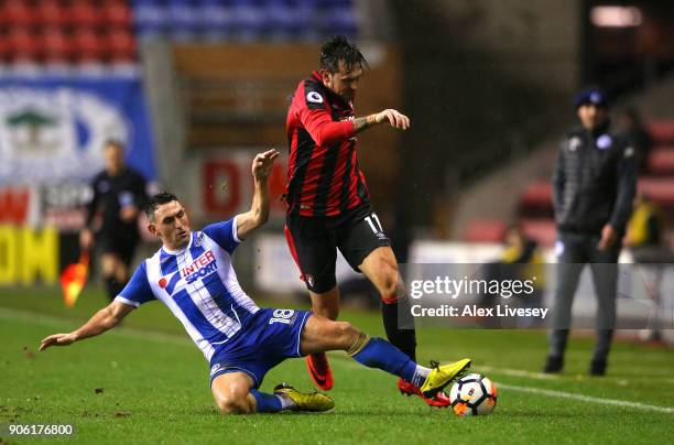Gary Roberts of Wigan Athletic tackles Charlie Daniels of AFC Bournemouth during The Emirates FA Cup Third Round Replay between Wigan and AFC...