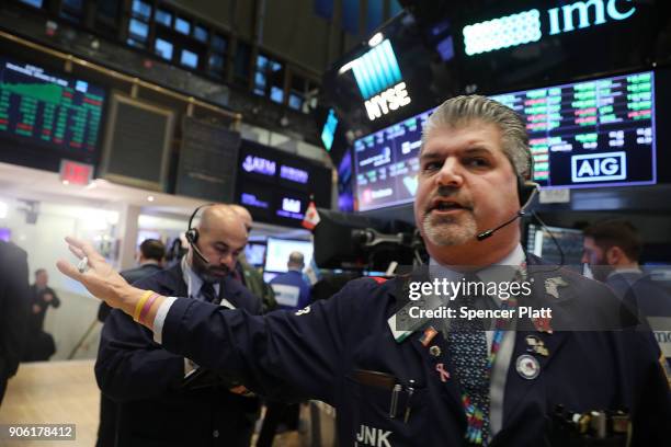 Traders work on the floor of the New York Stock Exchange on January 17, 2018 in New York City. The Dow Jones industrial average closed above 26,000...