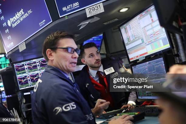 Traders work on the floor of the New York Stock Exchange on January 17, 2018 in New York City. The Dow Jones industrial average closed above 26,000...