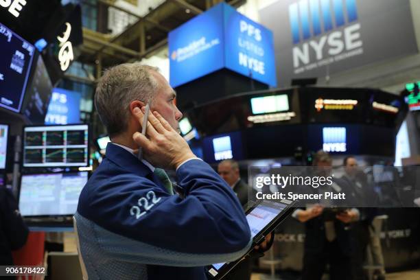 Traders work on the floor of the New York Stock Exchange on January 17, 2018 in New York City. The Dow Jones industrial average closed above 26,000...