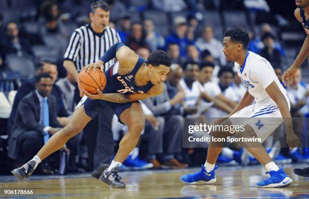 UConn Huskies guard Jalen Adams looks to get around Memphis Tigers guard Jeremiah Martin during the first half of a college basketball game between...