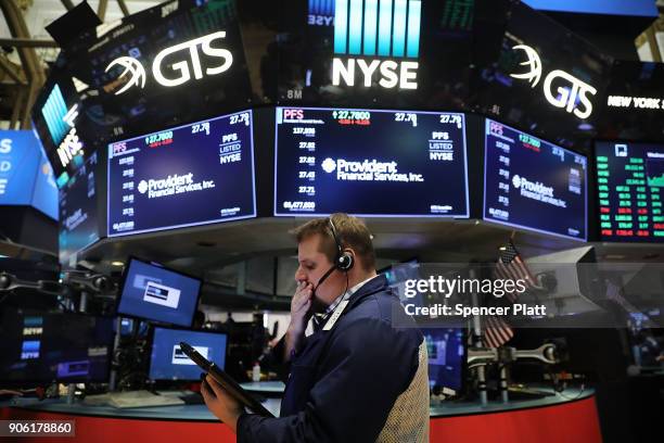 Traders work on the floor of the New York Stock Exchange on January 17, 2018 in New York City. The Dow Jones industrial average closed above 26,000...