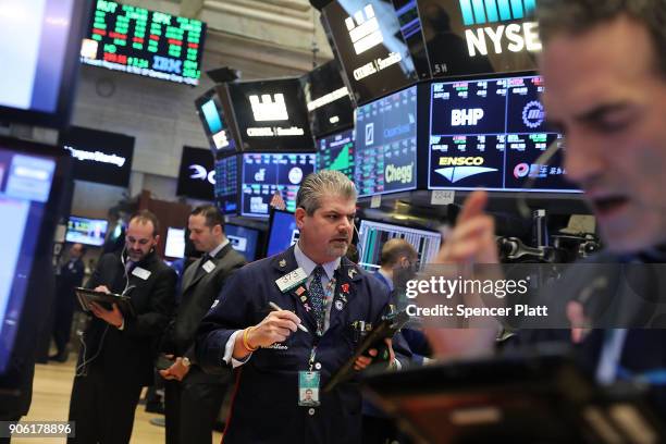 Traders work on the floor of the New York Stock Exchange on January 17, 2018 in New York City. The Dow Jones industrial average closed above 26,000...