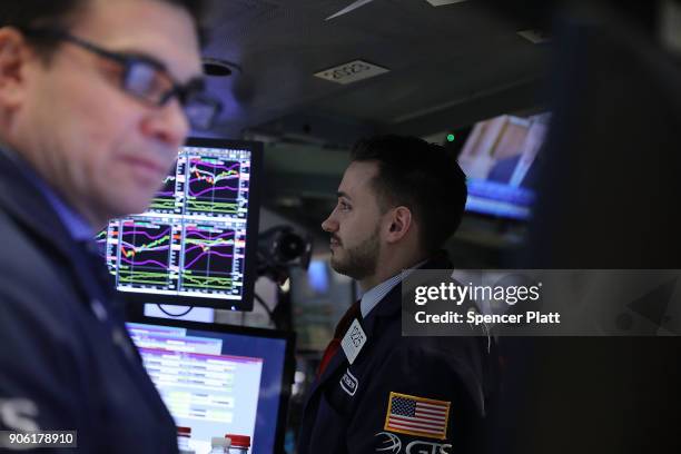 Traders work on the floor of the New York Stock Exchange on January 17, 2018 in New York City. The Dow Jones industrial average closed above 26,000...