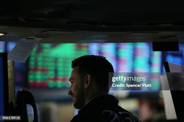 Traders work on the floor of the New York Stock Exchange on January 17, 2018 in New York City. The Dow Jones industrial average closed above 26,000...