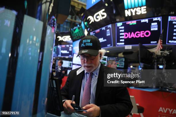 Traders work on the floor of the New York Stock Exchange on January 17, 2018 in New York City. The Dow Jones industrial average closed above 26,000...