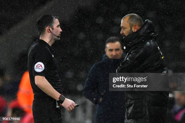 The referee speaks with Nuno Espirito Santo, Manager of Wolverhampton Wanderers during The Emirates FA Cup Third Round Replay between Swansea City...