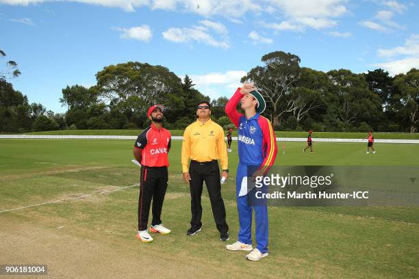 Arslan Khan of Canada, ICC Match Offical Devdas Govindjee and Lohan Louwrens of Namibia during the coin toss prior to the ICC U19 Cricket World Cup...