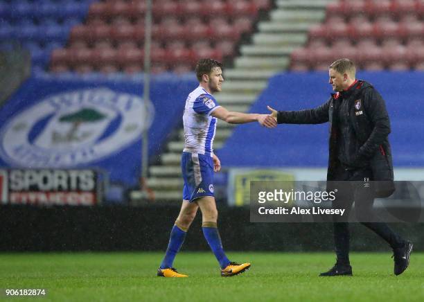 Callum Elder of Wigan Athletic shakes hands with Eddie Howe during The Emirates FA Cup Third Round Replay between Wigan and AFC Bournemouth at DW...