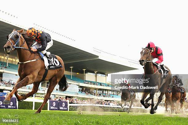 Jockey Damien Oliver riding Whobegotyou runs over the top of Mic Mac ridden by Danny Nikolic to win the Dato'Tan Chin Nam Stakes during the Tatts Cox...