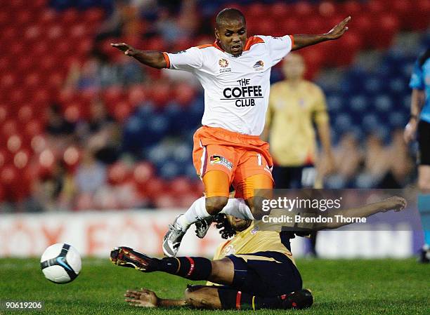 Henrique of the Roar jumps the tackle of Nikolai Topor-Stanley of the Jets during the round six A-League match between the Newcastle Jets and the...